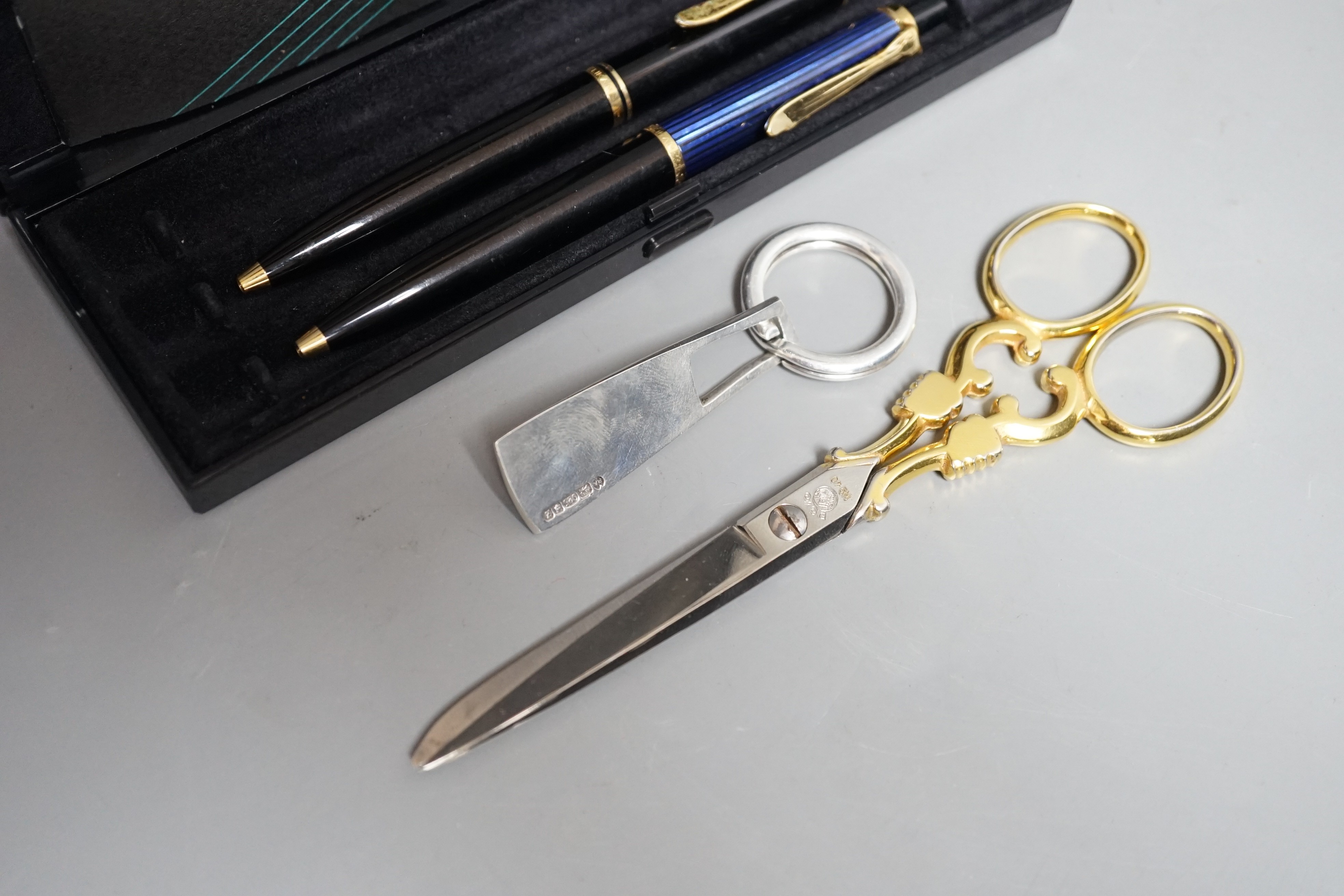 Two Pelikan ballpoint pens boxed with guarantee, 1996, a pair of Solingen scissors and a silver key ring 1999